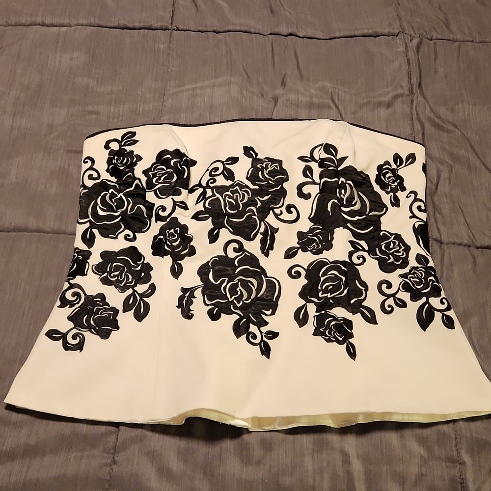 White corset top with black floral embroidery